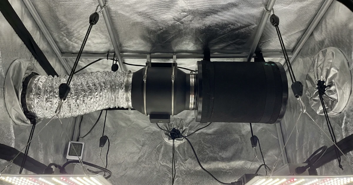 Extractor en línea y filtro de carbón activo instalados en el techo de un armario de cultivo interior completo